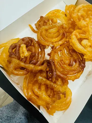 Freshly made jalebi in a takeout box at Lovely Sweets Saddletowne Calgary